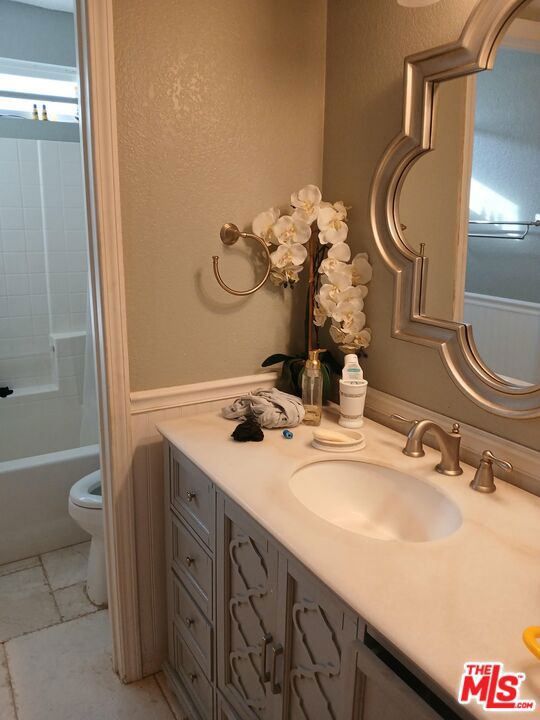 full bathroom with vanity, bathing tub / shower combination, toilet, and tile patterned floors