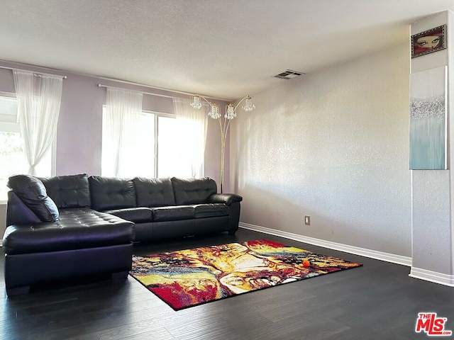 living room with wood-type flooring and a healthy amount of sunlight