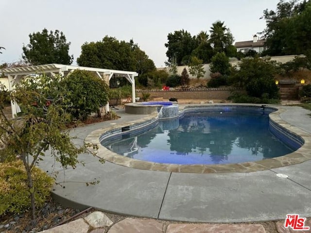 view of swimming pool with a patio, a pergola, and an in ground hot tub