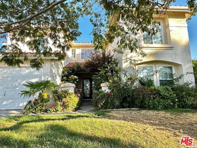 view of front facade featuring a garage and a front yard