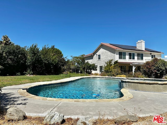 view of pool with a lawn