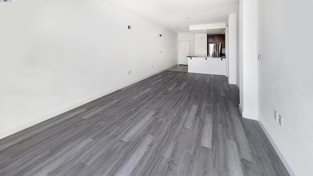 unfurnished living room featuring dark hardwood / wood-style flooring