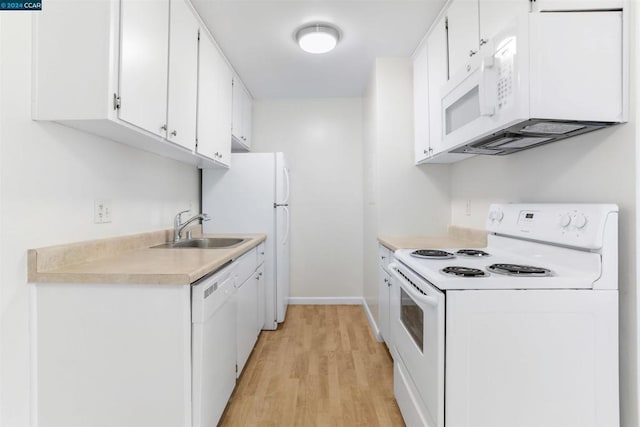 kitchen with sink, white cabinets, white appliances, and light wood-type flooring