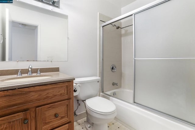 full bathroom featuring combined bath / shower with glass door, vanity, and toilet