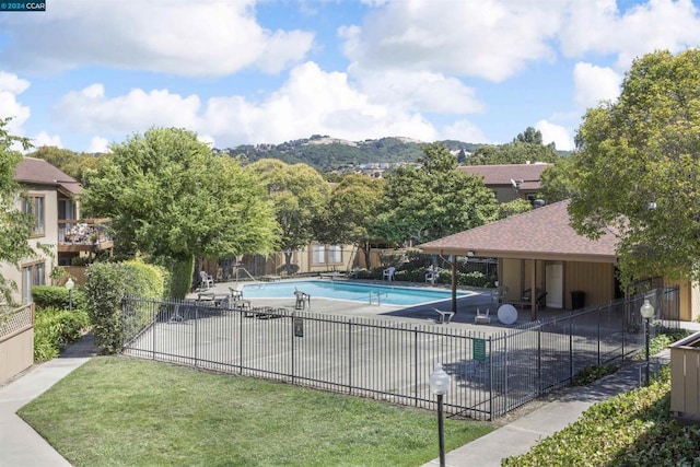 view of pool featuring a patio and a lawn