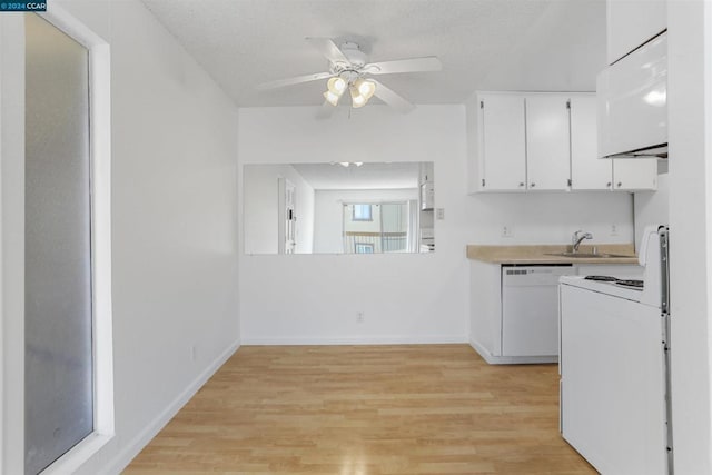 kitchen featuring white cabinets, light wood-type flooring, white appliances, and sink