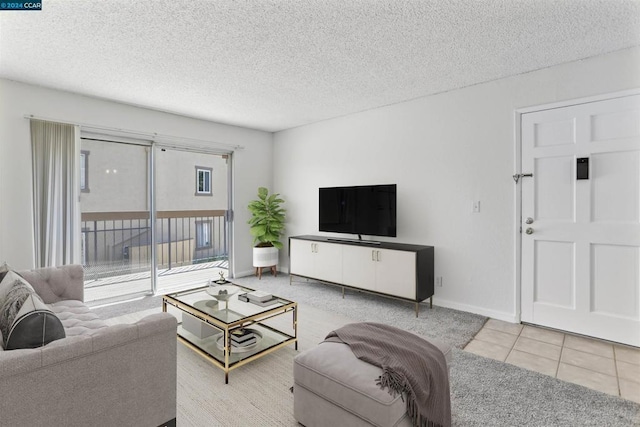 living room with light tile patterned floors and a textured ceiling