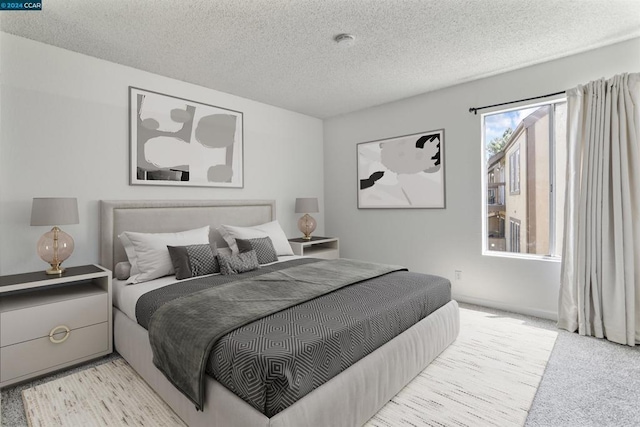 carpeted bedroom with a textured ceiling