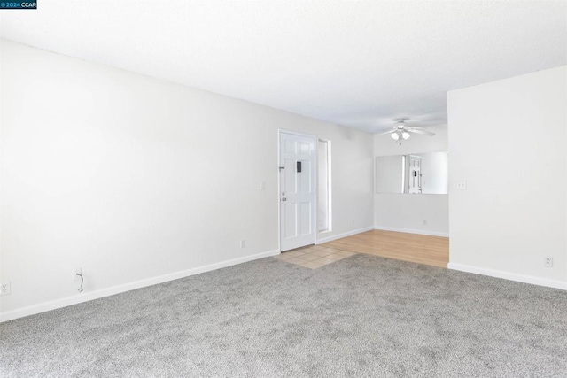 unfurnished room featuring light carpet