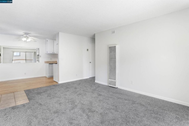 unfurnished living room with light carpet and ceiling fan