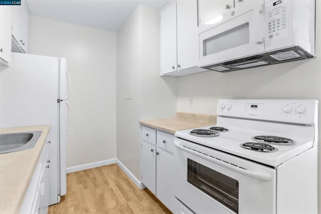 kitchen with white cabinetry, sink, light hardwood / wood-style floors, and white appliances