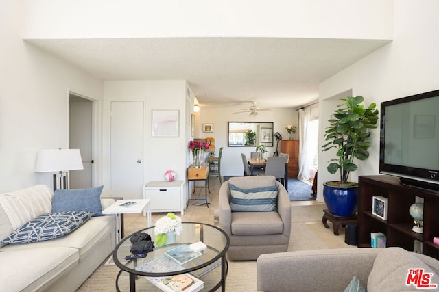 living room with light tile patterned floors and ceiling fan