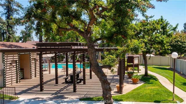 wooden deck featuring a fenced in pool