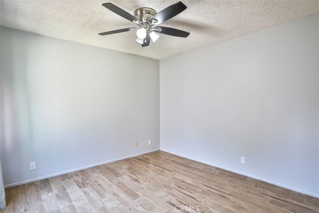 spare room featuring ceiling fan, light hardwood / wood-style floors, and a textured ceiling