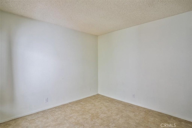 empty room with a textured ceiling