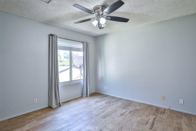 spare room featuring ceiling fan, light hardwood / wood-style flooring, and a textured ceiling