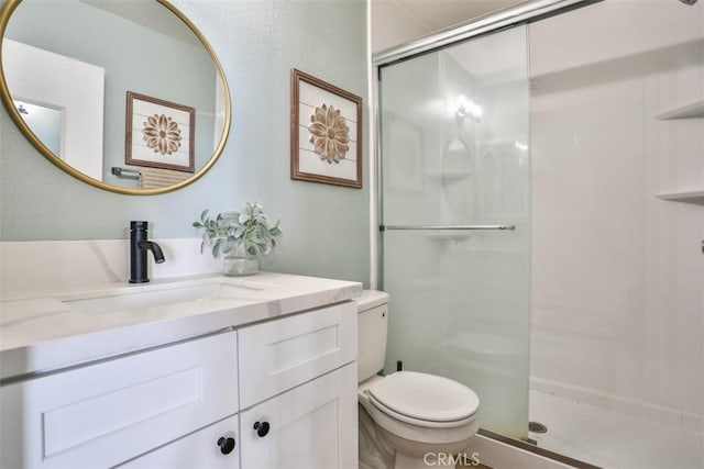 bathroom with vanity, toilet, and walk in shower