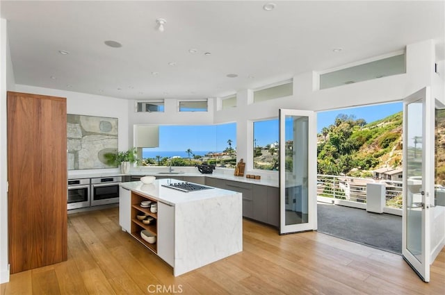 547 Temple Hills Dr, Laguna Beach, CA 92651 - kitchen featuring oven, light countertops, modern cabinets, and light wood-style floors