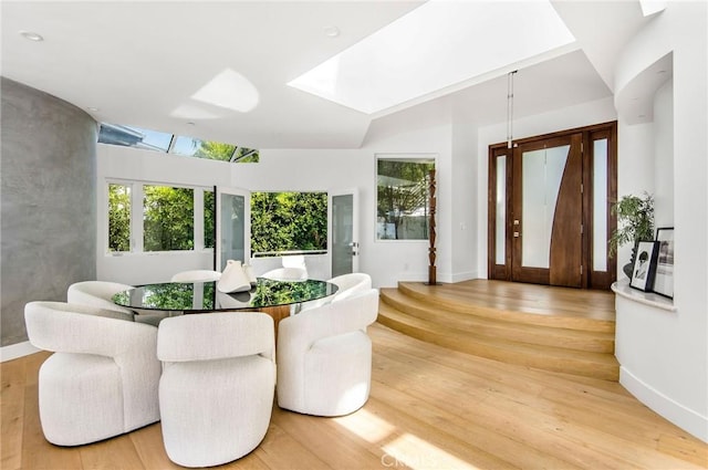interior space featuring a skylight and hardwood / wood-style flooring
