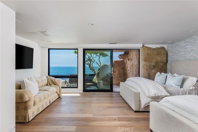 bedroom featuring access to exterior and wood finished floors