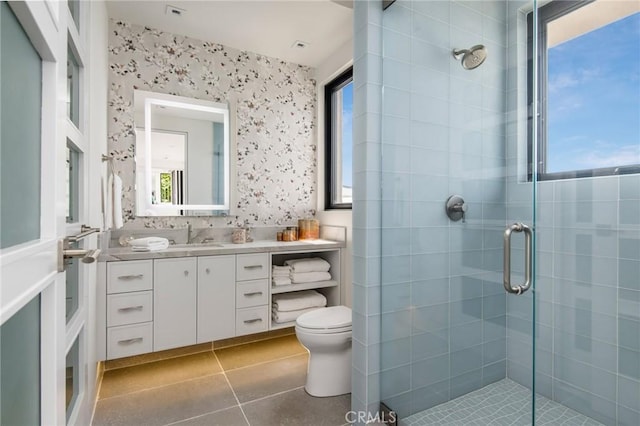 bathroom featuring wallpapered walls, toilet, tile patterned floors, vanity, and a shower stall