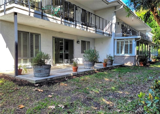 rear view of property with a patio area and a balcony