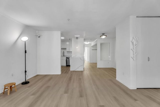 unfurnished living room with light wood-type flooring and sink