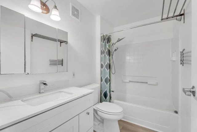 full bathroom featuring toilet, wood-type flooring, vanity, and shower / bath combo with shower curtain