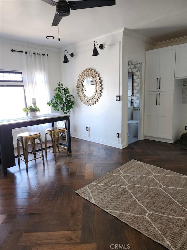 interior space featuring ceiling fan, ornamental molding, and dark parquet floors