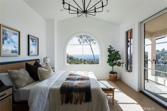 bedroom featuring dark hardwood / wood-style floors, an inviting chandelier, and vaulted ceiling