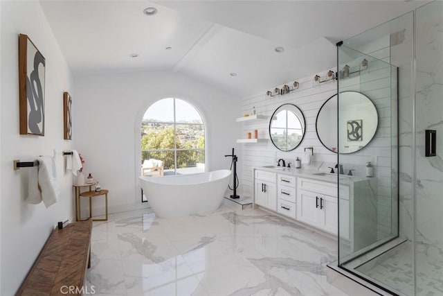 bathroom with vanity, independent shower and bath, and vaulted ceiling