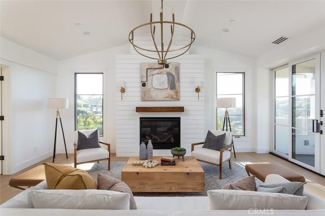 living room featuring plenty of natural light and vaulted ceiling