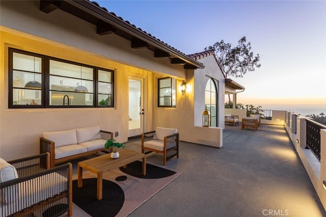 patio terrace at dusk with outdoor lounge area