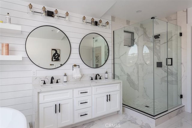 bathroom with vanity, a shower with shower door, and wooden walls