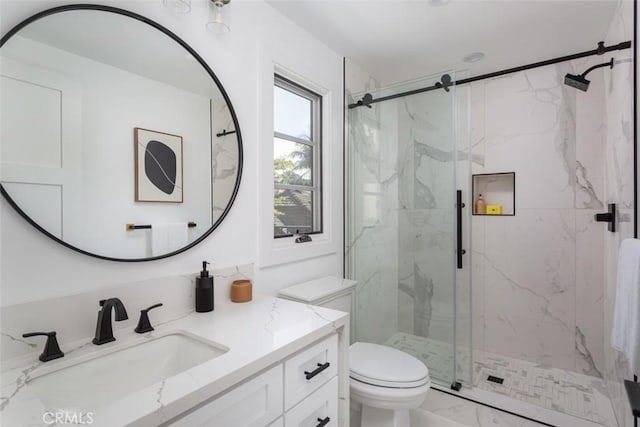 bathroom with vanity, an enclosed shower, and toilet