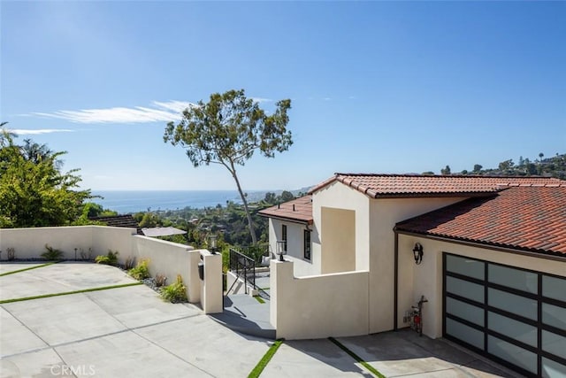 view of property exterior with a water view