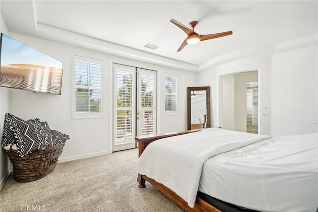 bedroom featuring access to exterior, light colored carpet, and ceiling fan