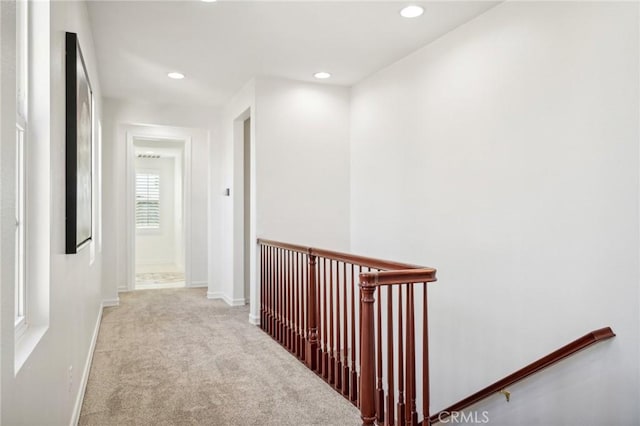 hallway featuring light colored carpet