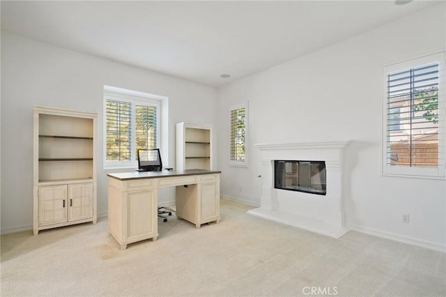 unfurnished office featuring light colored carpet