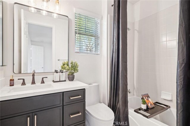 full bathroom featuring vanity, toilet, and shower / bath combo with shower curtain