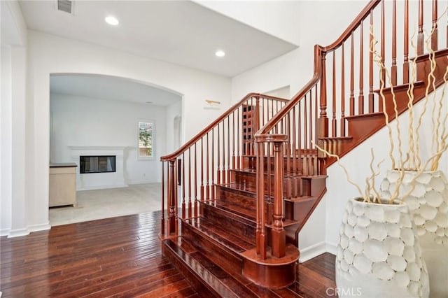 stairs featuring wood-type flooring