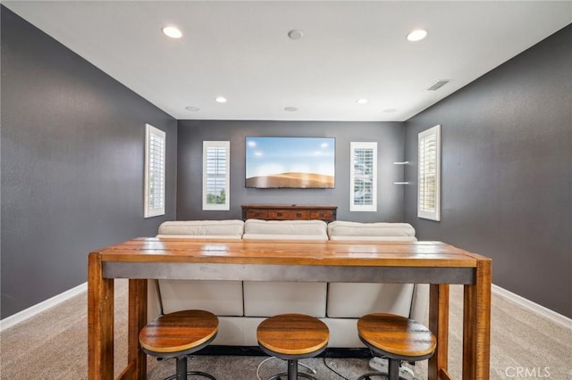 dining area featuring light colored carpet