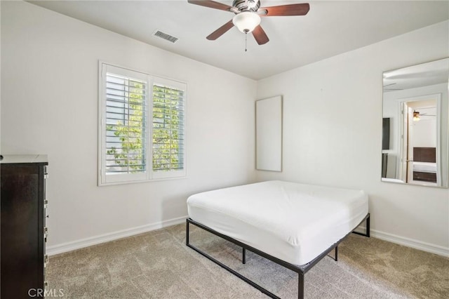 bedroom featuring ceiling fan and light carpet