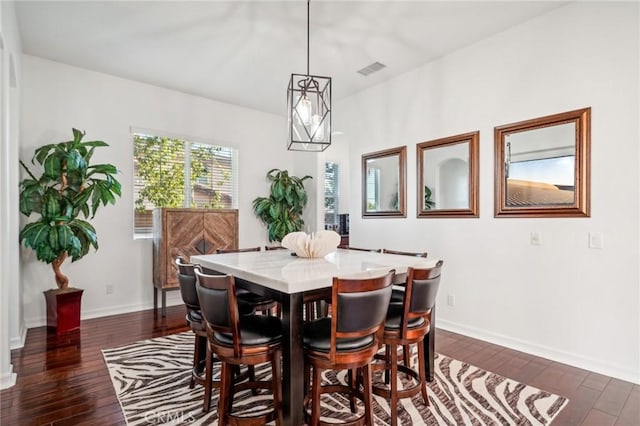 dining space with dark hardwood / wood-style floors