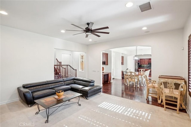 living room with light hardwood / wood-style floors and ceiling fan