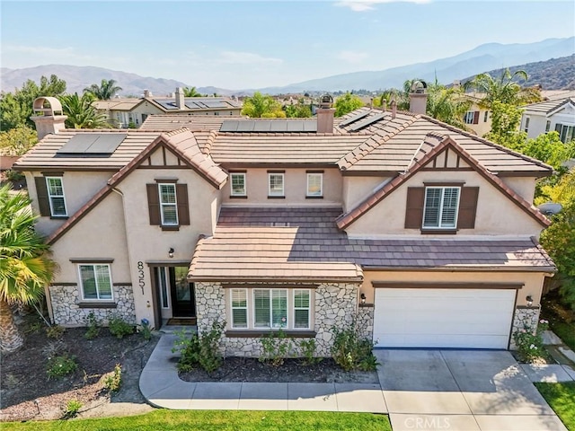 view of front of house featuring a mountain view and a garage