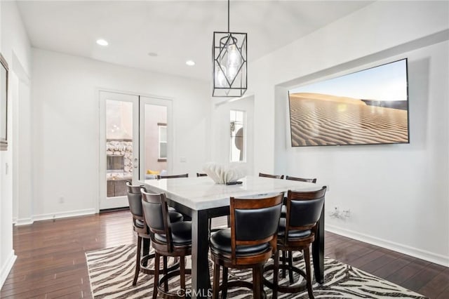 dining space featuring dark wood-type flooring