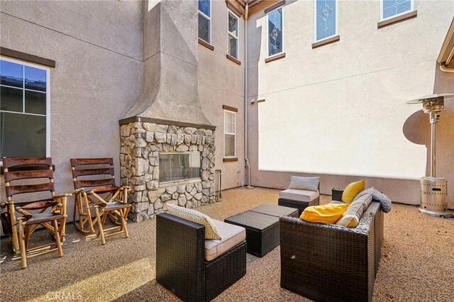 view of patio / terrace featuring an outdoor stone fireplace