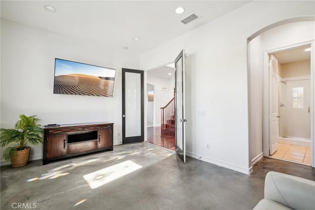 living room featuring concrete flooring