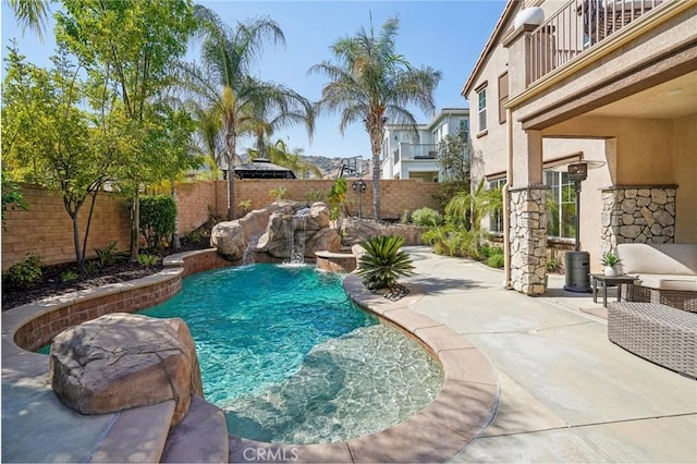 view of swimming pool featuring a patio and pool water feature